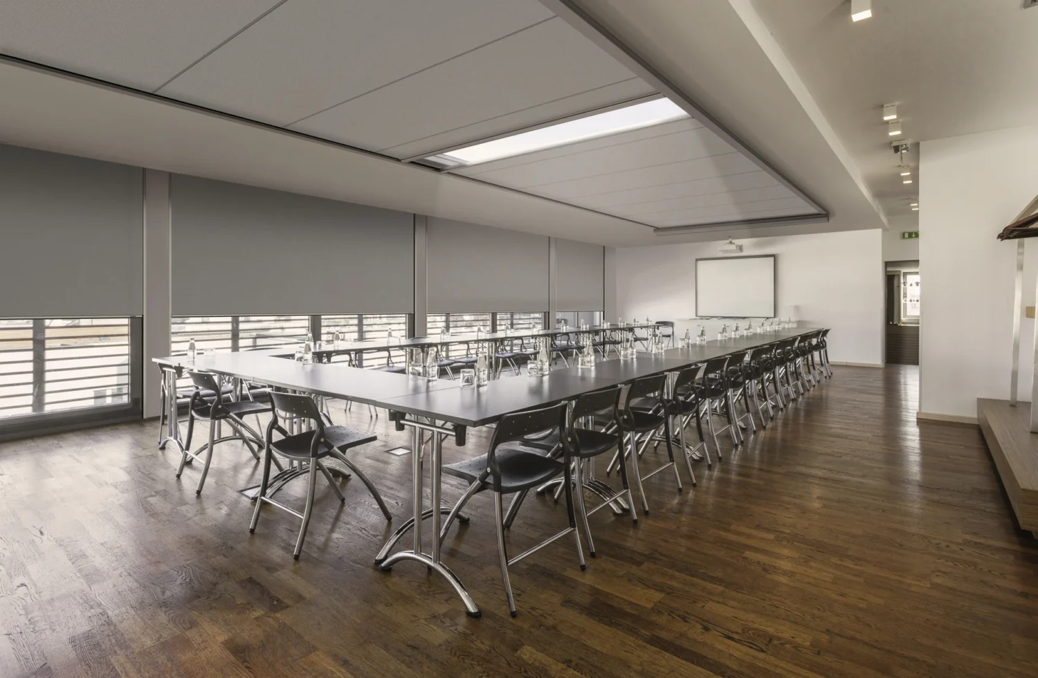 Konferenzraum mit langer Tischreihe und modernen Stühlen